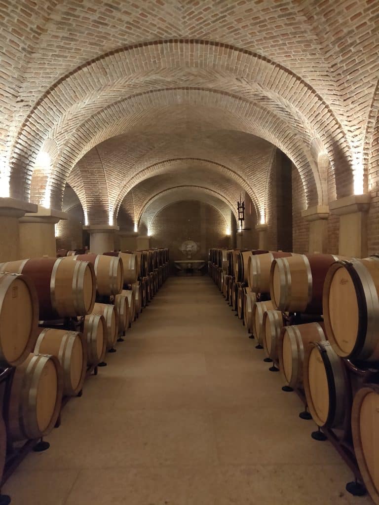 2021-05-06 15.05.02 Rows of oak barrels under the brick vaults of a Valpolicella cellar