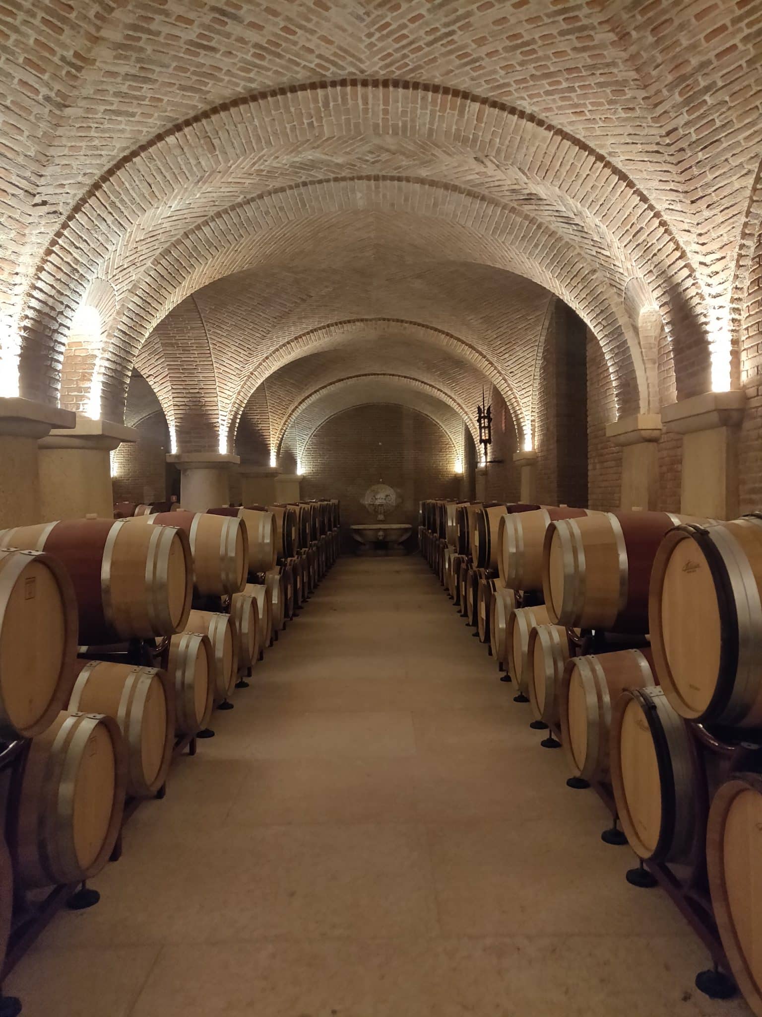 2021-05-06 15.05.02 Rows of oak barrels under the brick vaults of a Valpolicella cellar